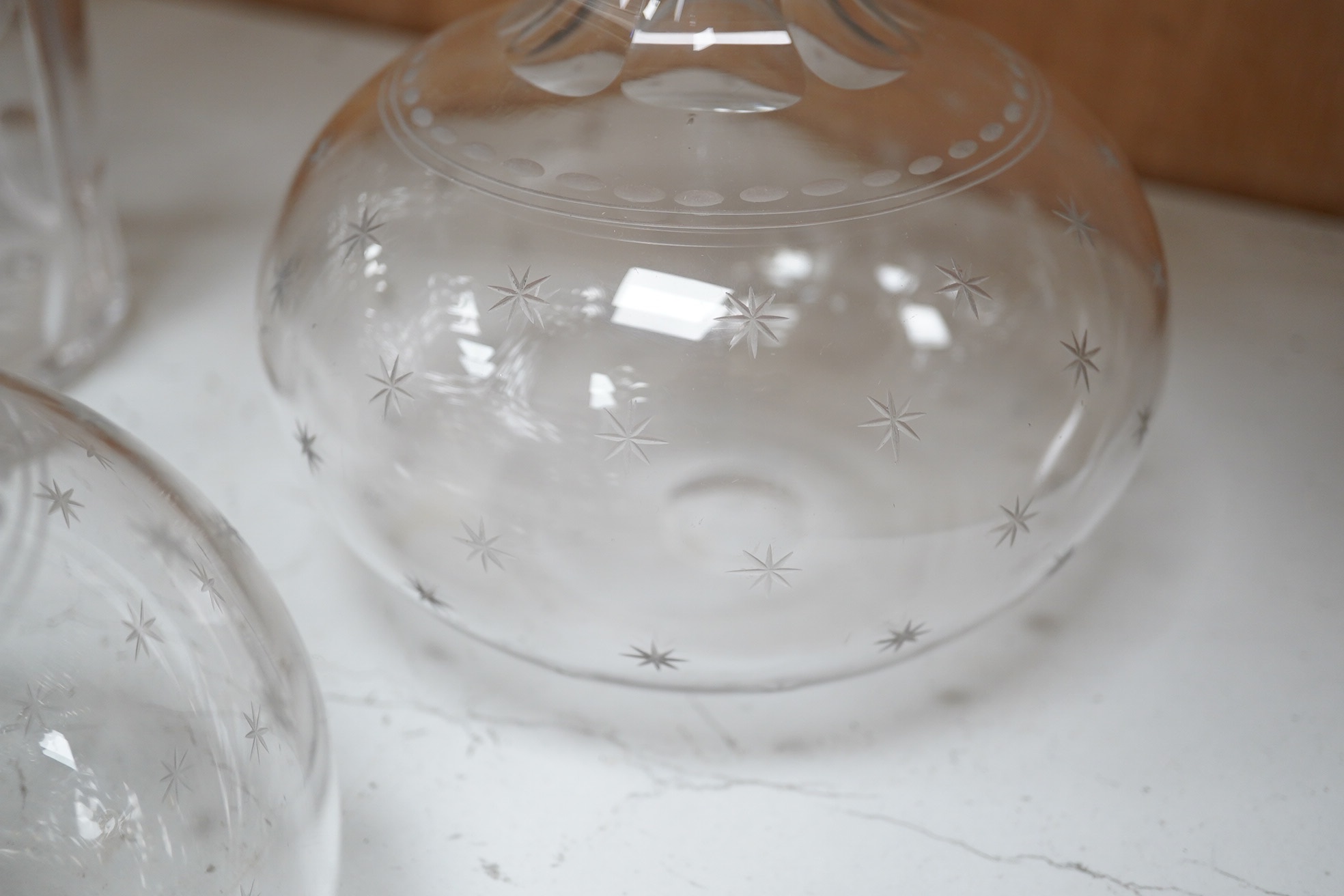 Six late 19th century and early 20th century cut glass decanters, including a pair of decanters with engraved star decoration, and four others. Condition - good